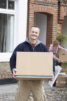 Professional movers loading boxes into a moving truck in Revesby