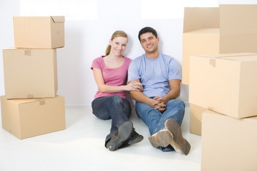 Movers carefully packing household items