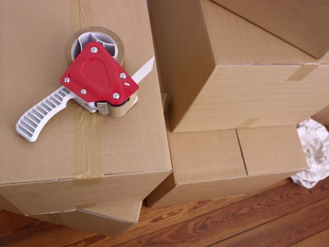 Movers packing boxes efficiently in Oxley home