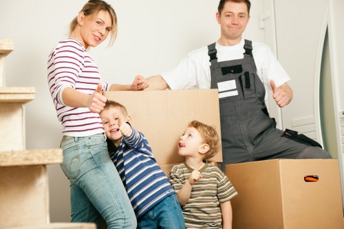 Movers carrying furniture into a new home in Crawley